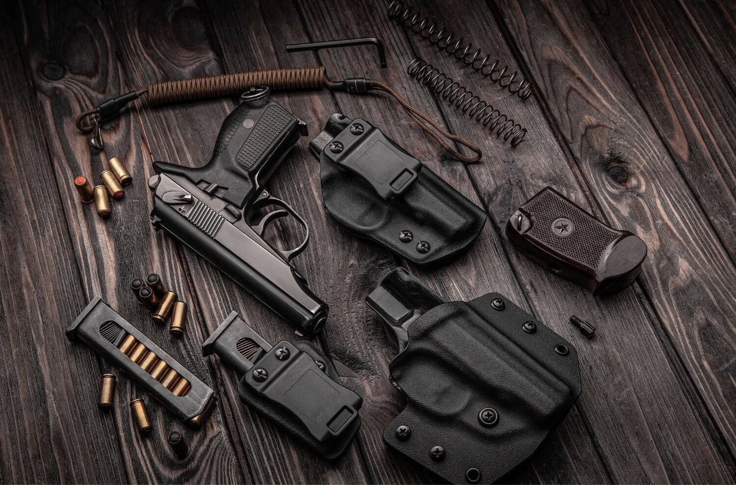 Various pistol accessories displayed on a dark table