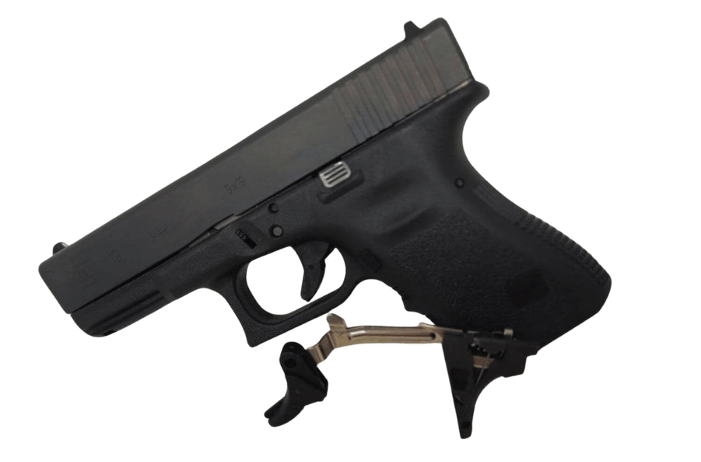 pistol with a Model G pull release trigger placed in front of it before installation